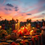 A vibrant outdoor celebration at sunset features people in traditional attire holding candles. A table is adorned with food, floral decorations, and numerous lit candles. Palm trees are silhouetted against a colorful sky in the background.