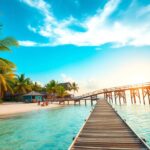 A wooden pier stretches over the clear turquoise waters toward huts on stilts, promising a perfect winter escape for Canadians. Palm trees fringe the sandy beach on the left side under a sunlit sky, suggesting a tranquil setting in beautiful Belize.