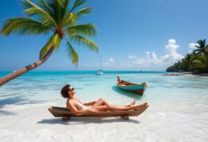 A person in a swimsuit relaxes on a wooden lounge chair on a tropical beach, with clear turquoise water, a small boat nearby, palm trees, and a sailboat in the distance under a sunny sky.